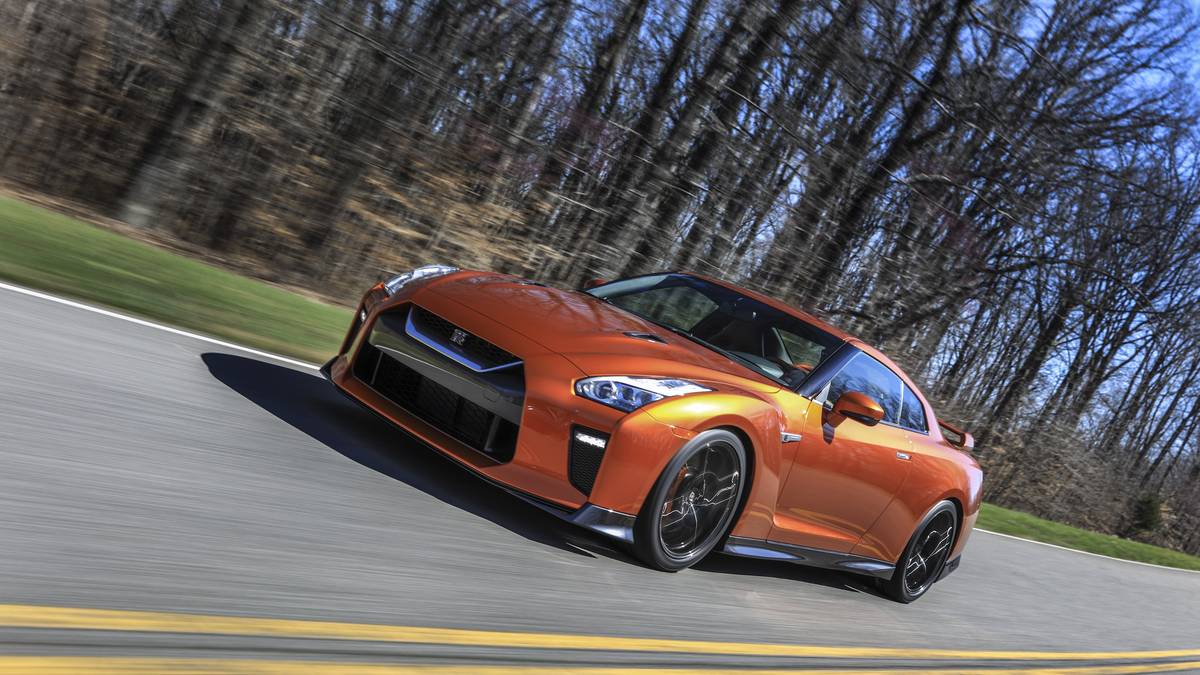 The 2017 GT-R's exterior receives a thorough makeover. The new "V-motion" grille, one of Nissan's latest design signatures, has been slightly enlarged to provide better engine cooling and now features a matte chrome finish and an updated mesh pattern. A new hood, featuring pronounced character lines flowing flawlessly from the grille, has been reinforced to enhance stability during high-speed driving. A freshly designed front spoiler lip and front bumpers with finishers situated immediately below the headlamps give the new GT-R the look of a pure-bred racecar, while generating high levels of front downforce.